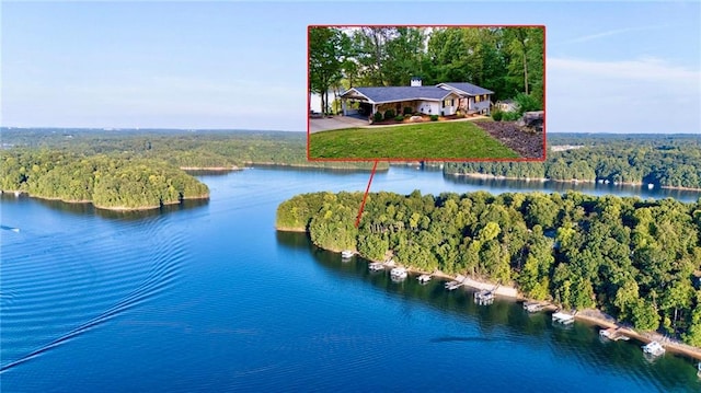 birds eye view of property with a water view