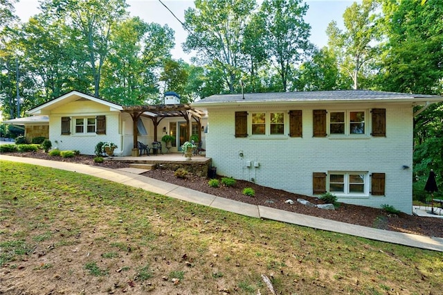 ranch-style home featuring a front yard and a patio