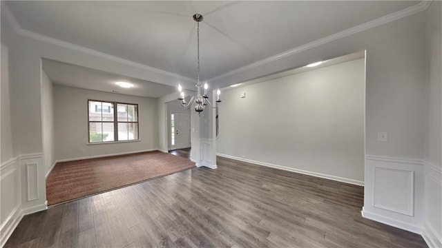 unfurnished dining area with an inviting chandelier, crown molding, and dark wood finished floors