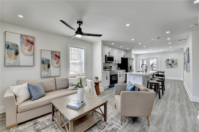 living room with light wood-style floors and a healthy amount of sunlight