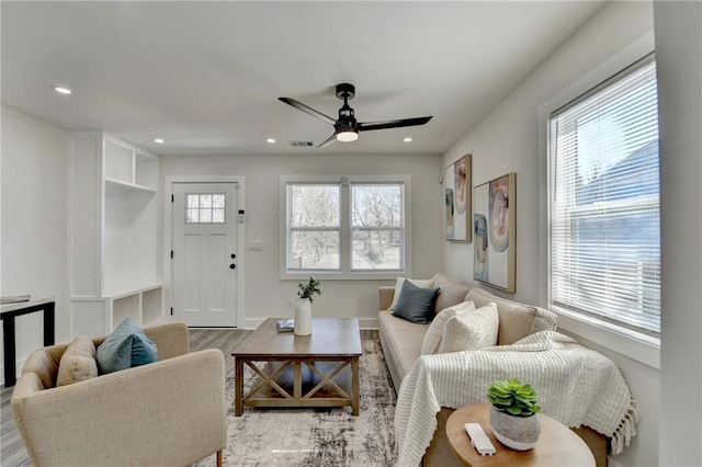 living room featuring plenty of natural light, visible vents, and recessed lighting