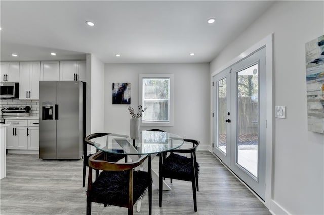 dining room featuring light wood-style floors, recessed lighting, baseboards, and french doors