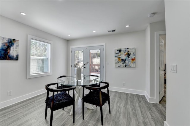 dining area featuring french doors, plenty of natural light, visible vents, and baseboards