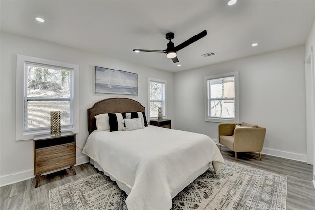 bedroom with visible vents, baseboards, and multiple windows