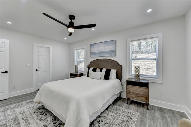 bedroom featuring ceiling fan, recessed lighting, wood finished floors, and baseboards