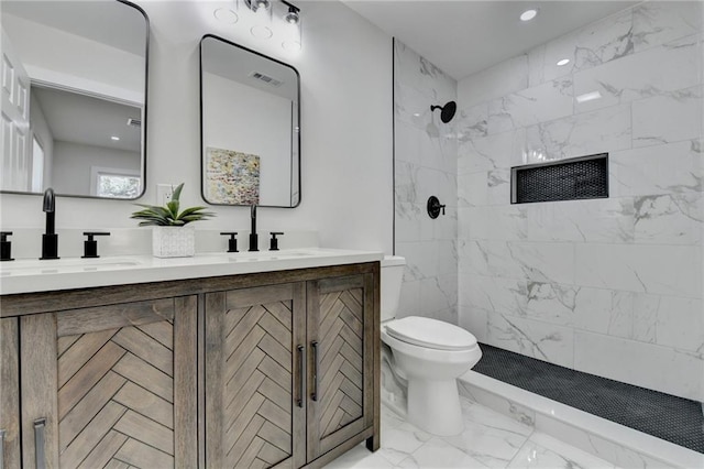 bathroom with marble finish floor, double vanity, visible vents, toilet, and a sink