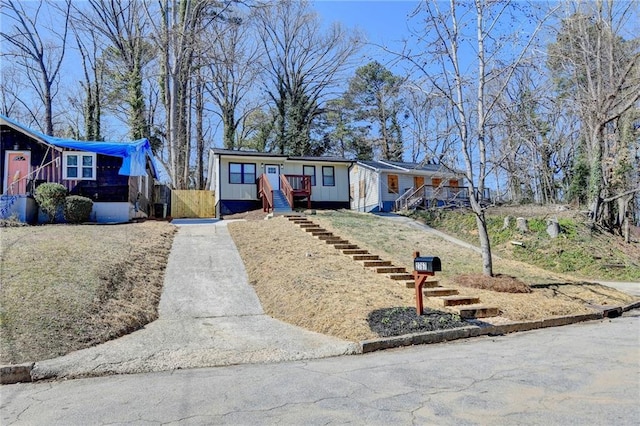 view of front of property with driveway and stairs