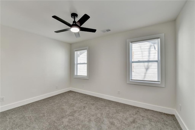 unfurnished room featuring light carpet, baseboards, and visible vents