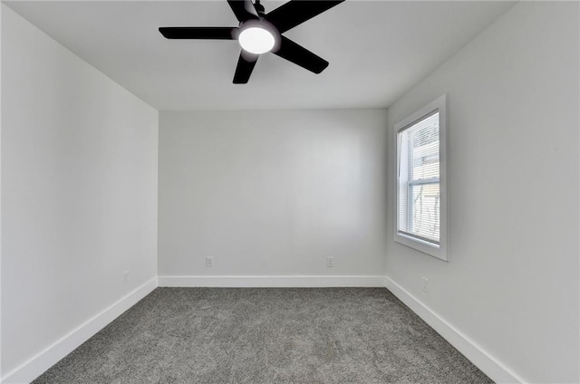 empty room featuring baseboards, a ceiling fan, and light colored carpet