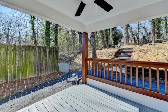 wooden terrace featuring a ceiling fan and fence