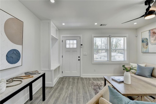 entryway featuring baseboards, light wood finished floors, visible vents, and recessed lighting