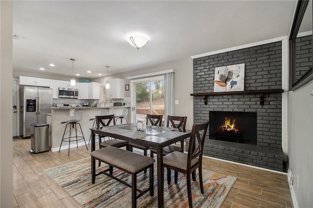 dining space featuring a brick fireplace