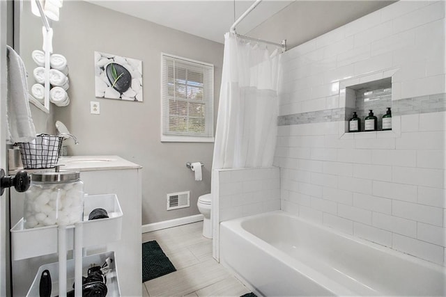 full bathroom featuring tile patterned flooring, shower / bath combination with curtain, toilet, and sink