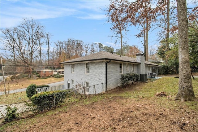 view of property exterior with central AC