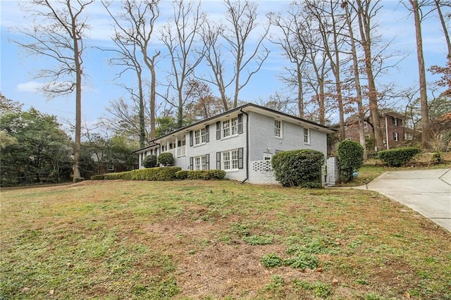 view of property exterior featuring a lawn