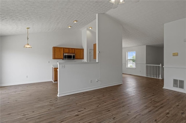 1910 Towne Park Dr, Mcdonough, GA 30252 - unfurnished living room with dark wood-style flooring, baseboards, ceiling fan, and high vaulted ceiling