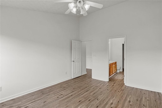 1910 Towne Park Dr, Mcdonough, GA 30252 - unfurnished room with a ceiling fan, wood finished floors, baseboards, and high vaulted ceiling