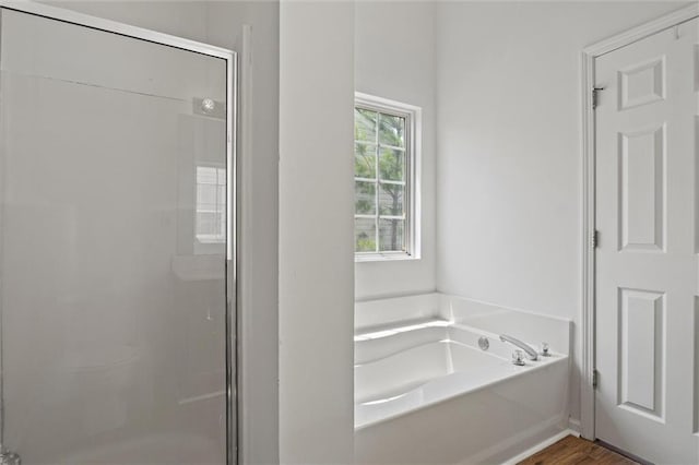 1910 Towne Park Dr, Mcdonough, GA 30252 - bathroom with a garden tub, a shower stall, wood finished floors, and toilet