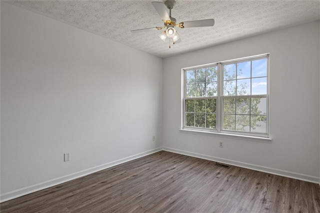1910 Towne Park Dr, Mcdonough, GA 30252 - unfurnished room with dark wood-type flooring, baseboards, a textured ceiling, and ceiling fan