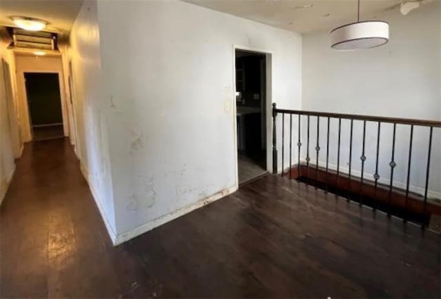 hallway with dark hardwood / wood-style flooring