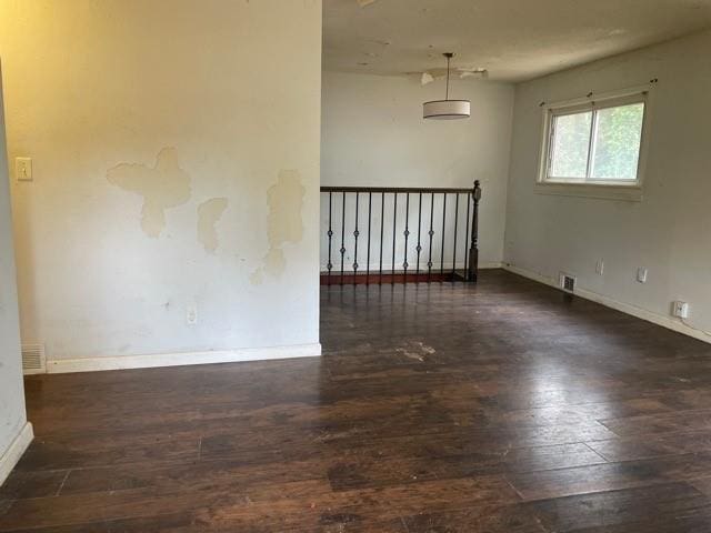 spare room with dark wood-type flooring