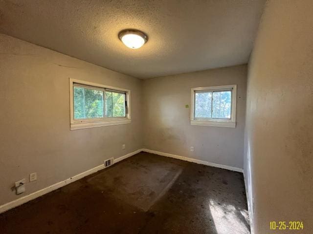 empty room with a textured ceiling