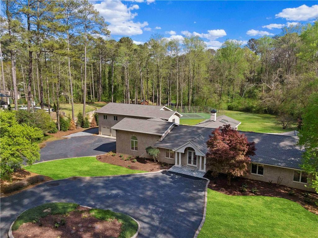 860 Crest Valley Dr, Sandy Springs, GA 30327 - view of subject property featuring a heavily wooded area