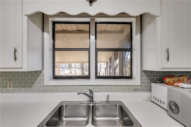 kitchen with sink and white cabinetry