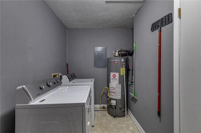 washroom with water heater, a textured ceiling, electric panel, and washing machine and dryer