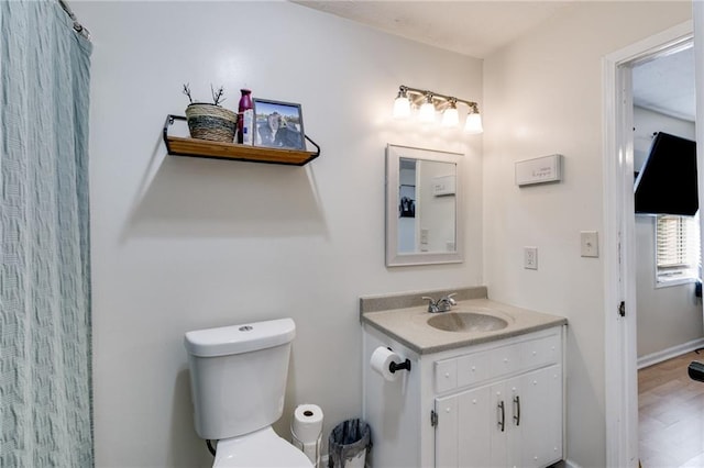 bathroom featuring hardwood / wood-style floors, toilet, and vanity