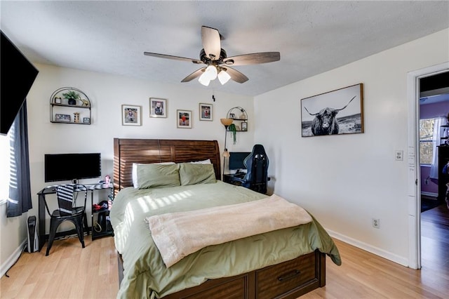 bedroom with ceiling fan and light hardwood / wood-style flooring