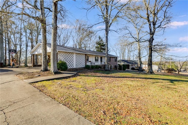 ranch-style house with a front lawn and a porch