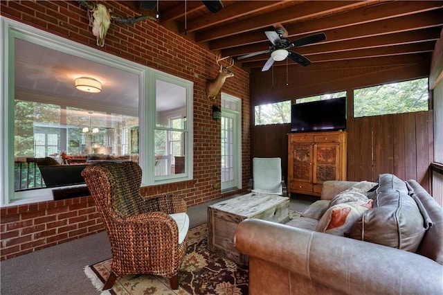 sunroom / solarium with beam ceiling, ceiling fan, and plenty of natural light