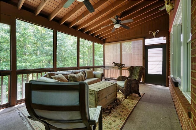 sunroom / solarium with lofted ceiling with beams, plenty of natural light, and wooden ceiling