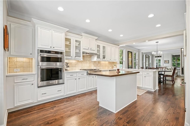 kitchen with white cabinetry, appliances with stainless steel finishes, and a kitchen island