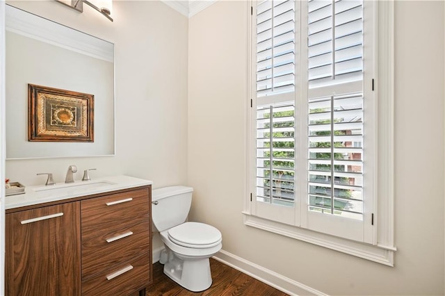 bathroom featuring hardwood / wood-style floors, vanity, toilet, and ornamental molding