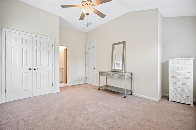 unfurnished bedroom with ceiling fan, lofted ceiling, and light colored carpet