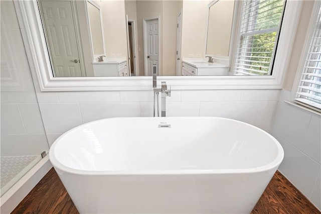 bathroom featuring wood-type flooring, separate shower and tub, and vanity