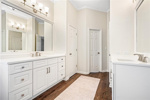 bathroom featuring hardwood / wood-style floors, vanity, and crown molding