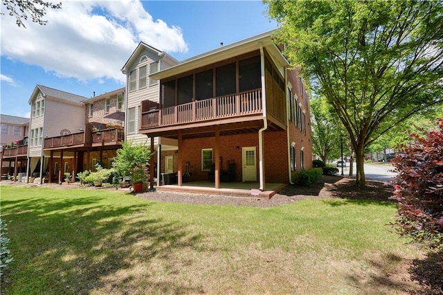 rear view of house with central AC, a sunroom, a patio, and a yard