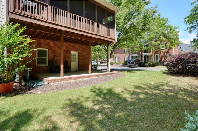 view of yard featuring cooling unit, a patio, and a sunroom