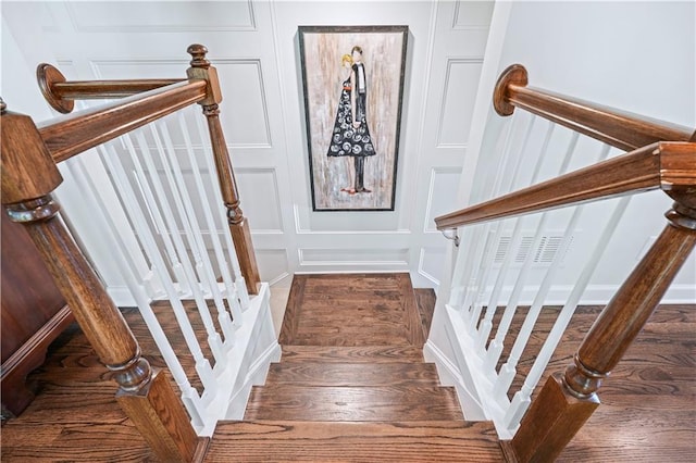 staircase with wood-type flooring