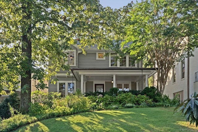 rear view of house featuring a lawn