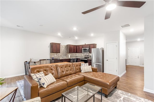 244 Grand Central Way, Cartersville, GA 30120 - living area featuring light wood finished floors, ceiling fan, baseboards, and recessed lighting