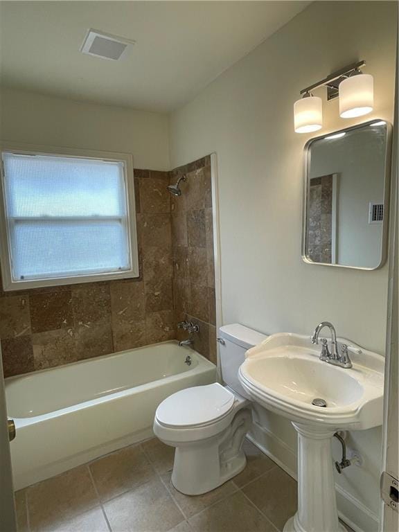 bathroom with visible vents, shower / tub combination, toilet, and tile patterned floors