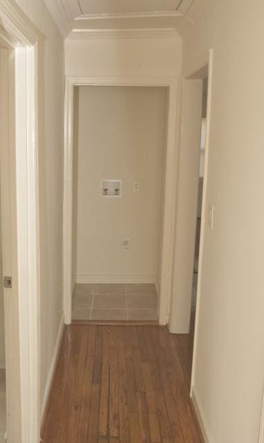 hallway featuring dark wood-type flooring, attic access, and crown molding