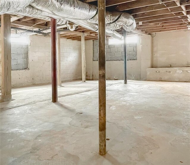 empty room featuring ornamental molding, wood finished floors, visible vents, and baseboards