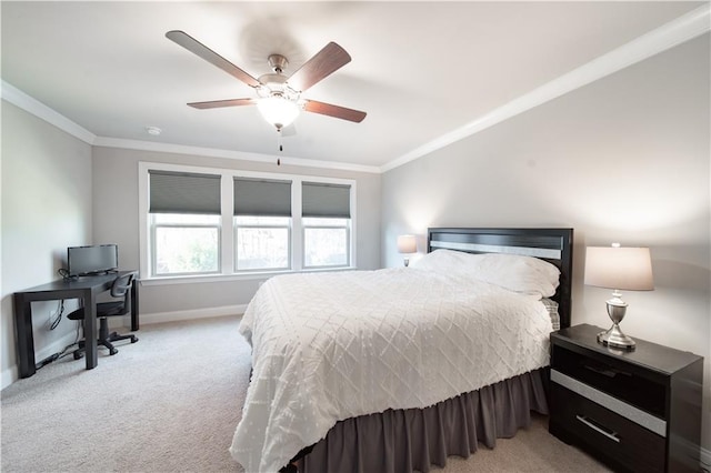 carpeted bedroom featuring ceiling fan and crown molding