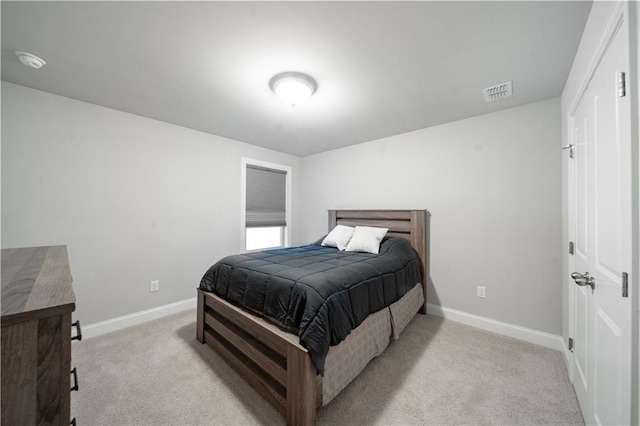 bedroom featuring light colored carpet