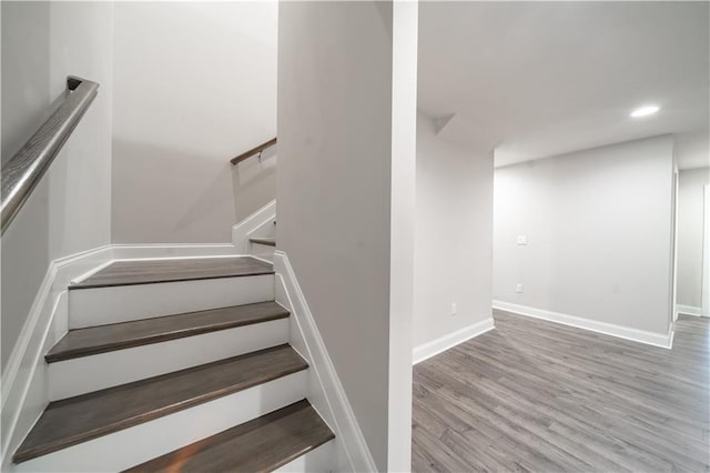 staircase with hardwood / wood-style flooring